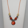 Necklace with red and beige beads on a white background