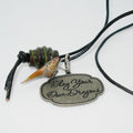Necklace with pendant that says 'Slay Your Own Dragons' on a white background