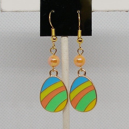 Colorful easter egg earrings on a stand with a neutral background