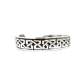 photo of a silver cuff bracelet with a Celtic pattern and black oxidation on a white background.