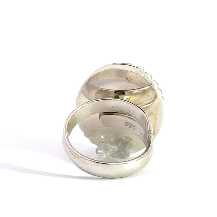 photo of a silver faceted oval amethyst ring with dots details in the frame on a white background rear view