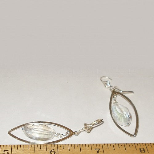 Silver earrings with teardrop-shaped crystals on a white background with a ruler for scale.
