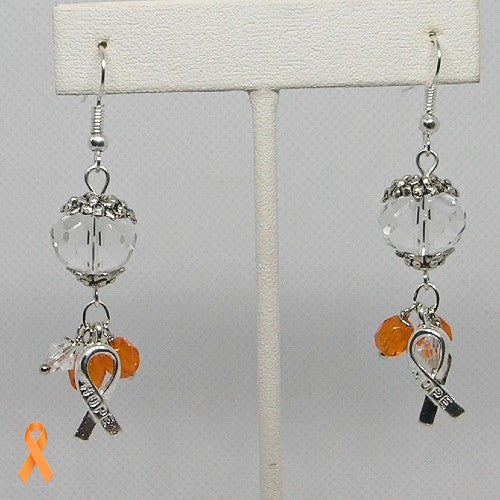 Earrings with orange and clear glass beads and Hope ribbon charms on a gray background