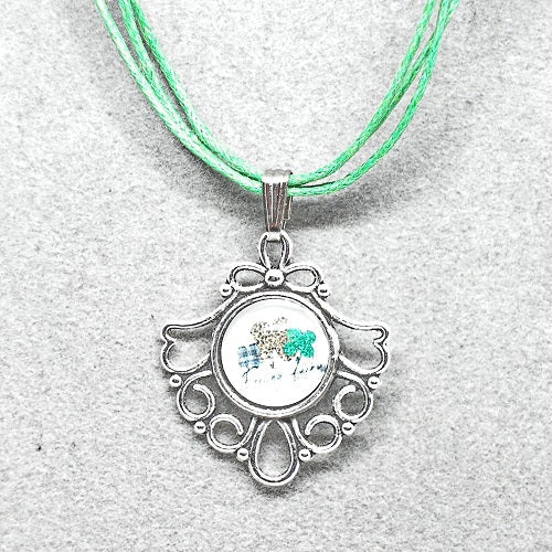 Necklace with a silver pendant featuring a design on a light gray background