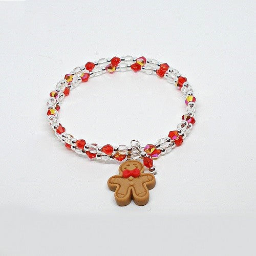 Bracelet with red and clear beads and a gingerbread man charm on a white background