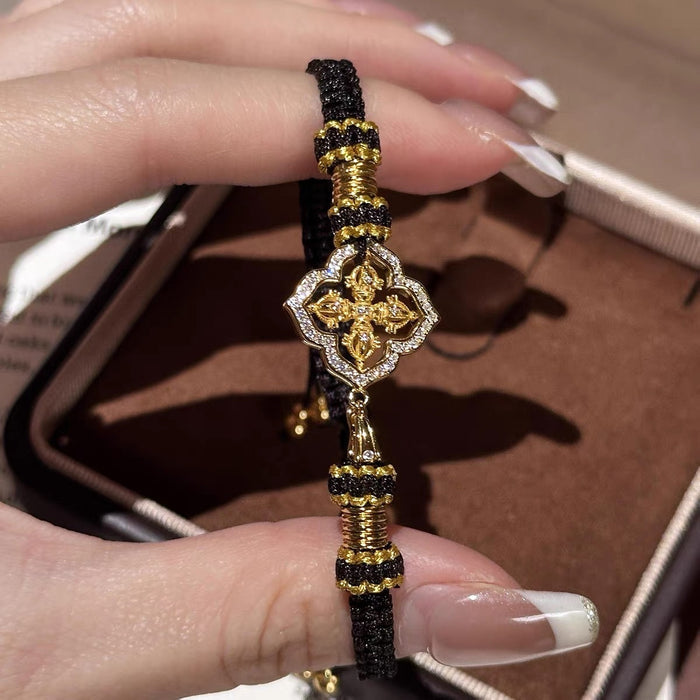Elegant, bold, and full of refined detail, the Golden Clover Bracelet is a striking piece designed for someone who loves classic black and gold styling. Featuring a clover-inspired centerpiece with golden detailing and sparkling crystal-style accents, this bracelet brings a rich, polished look while the braided cord keeps it comfortable and easy to wear.