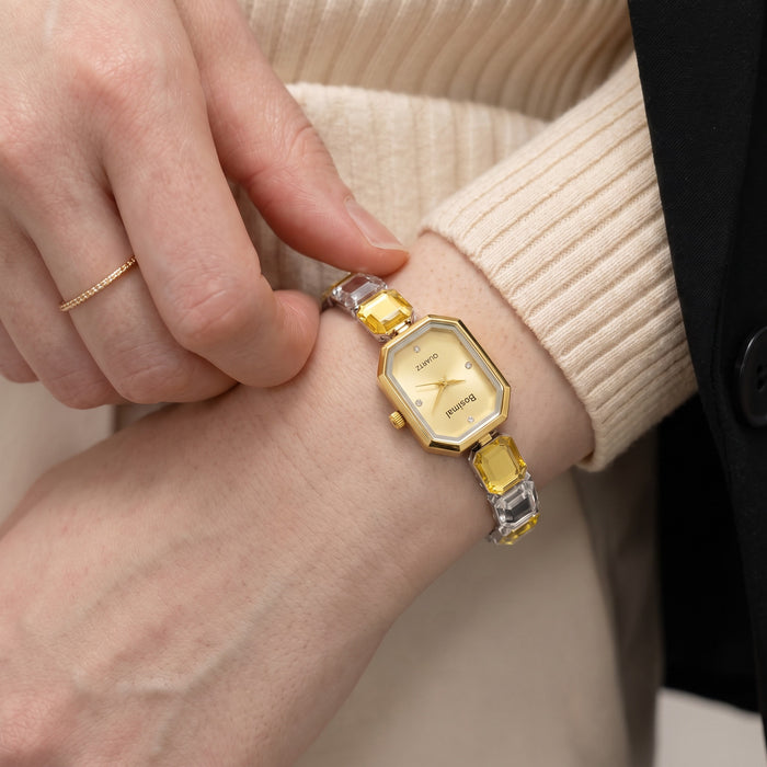 Elegant, polished, and beautifully feminine, the Golden Mosaic Watch is made for someone who loves graceful timepieces with a distinctive jewelry-inspired touch. Designed with a refined octagonal dial, dual-tone metallic detailing, and faceted bracelet links, this watch brings a radiant modern glow that feels perfect for everyday styling, office wear, special occasions, or thoughtful gifting.