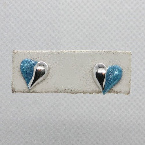Heart-shaped earrings with blue and silver colors on a white card against a gray background