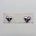 Heart-shaped earrings on a white card with a gray background