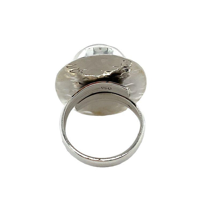 Photo of  a silver oval white moonstone ring on a white background Rear view