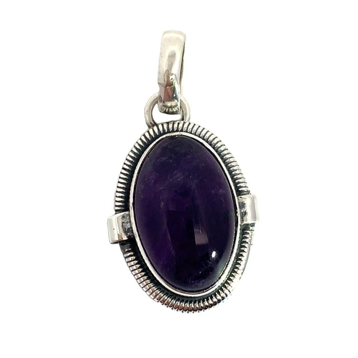 photo of a silver oval amethyst cabochon pendant on a white background