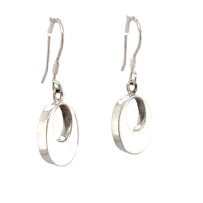 photo of a silver oval drop earring with an opening in the middle  on a white background
