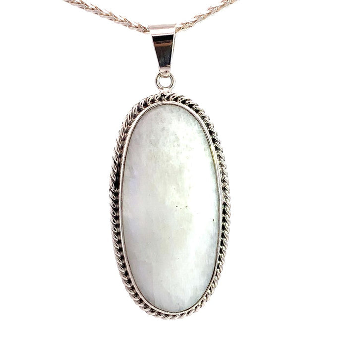 photo of a long oval silver white moonstone pendant on a white background