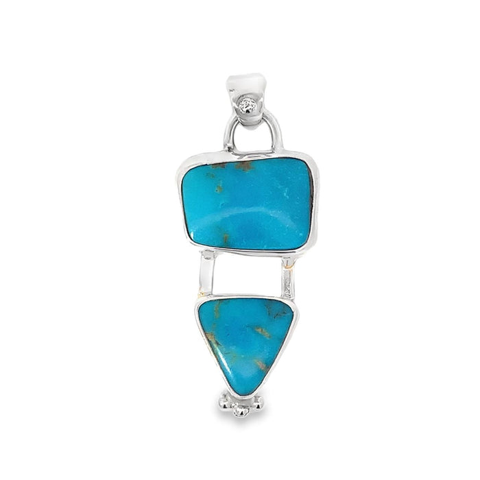 photo of a silver pendant with two bezel set turquoises taken on a white background