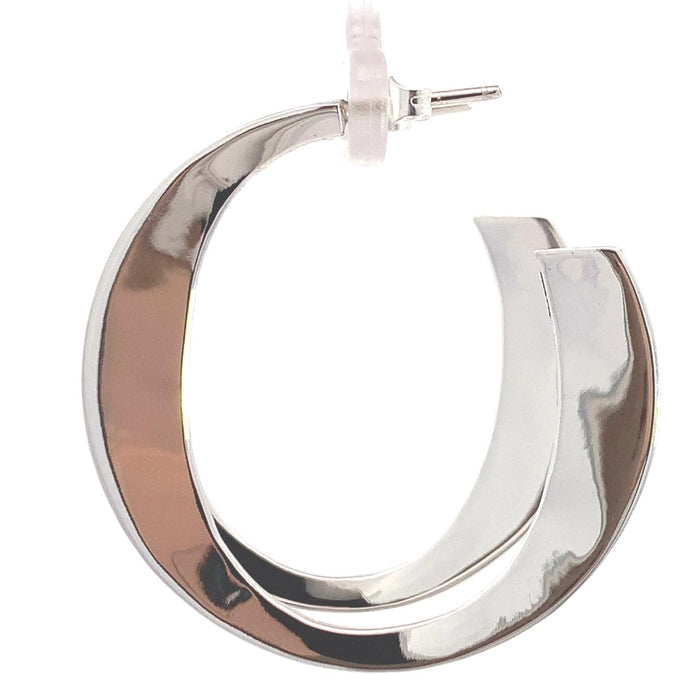 photo of a wide tapering silver hoop earring on a white background side view