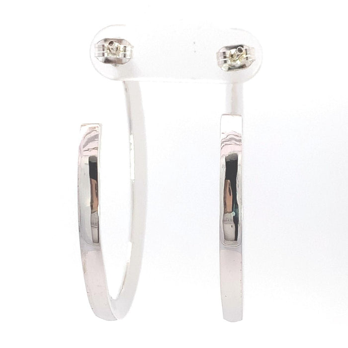 photo of a wide tapering silver hoop earring on a white background rear view