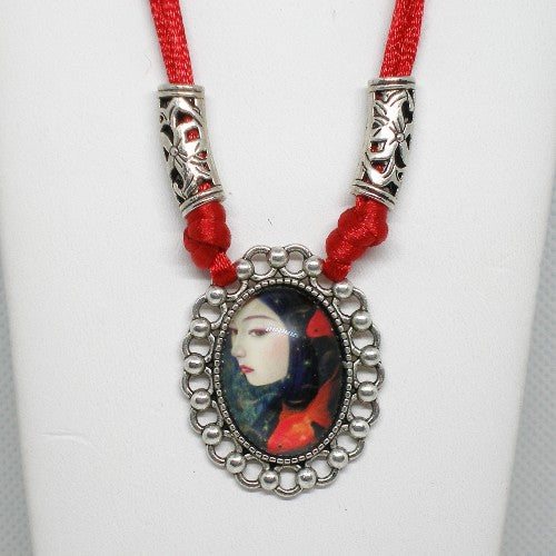 Necklace with a pendant featuring a portrait on a white background