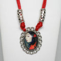 Necklace with a pendant featuring a portrait on a white background