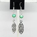 Celtic knot earrings with green beads on a white background