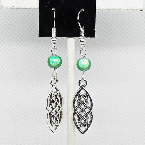Celtic knot earrings with green beads on a white background