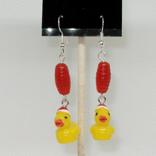 Rubber duck earrings with red beads on a white background