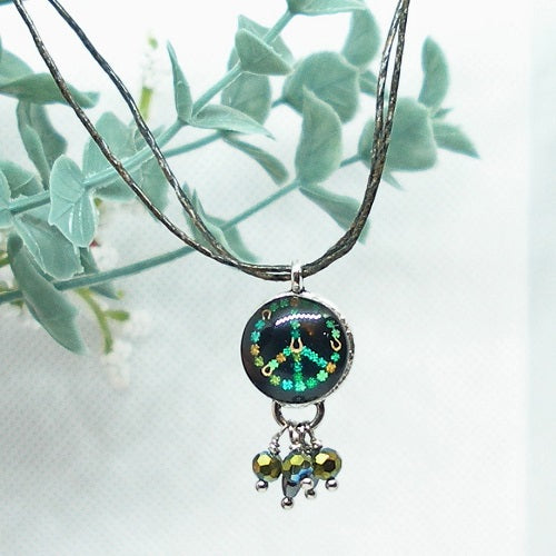 Necklace with a peace symbol pendant and beads against a light background