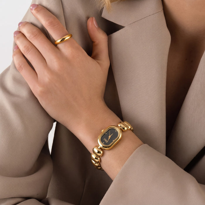 Elegant, polished, and beautifully feminine, the Luxe Oval Watch is made for someone who loves graceful timepieces with a refined jewelry-inspired touch. Designed with a smooth oval dial, rounded bracelet links, and a glossy metallic finish, this watch brings a sophisticated glow that feels perfect for everyday styling, office wear, special occasions, or thoughtful gifting.