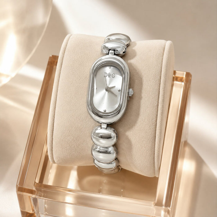 Elegant, polished, and beautifully feminine, the Luxe Oval Watch is made for someone who loves graceful timepieces with a refined jewelry-inspired touch. Designed with a smooth oval dial, rounded bracelet links, and a glossy metallic finish, this watch brings a sophisticated glow that feels perfect for everyday styling, office wear, special occasions, or thoughtful gifting.