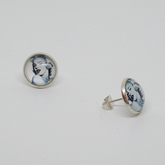 Pair of earrings with a portrait design on a light gray background
