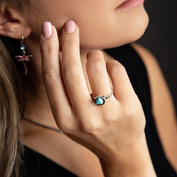 photo of a brunette model wearing a silver faceted round turquoise ring
