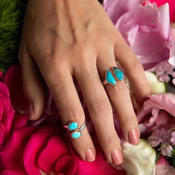 Sterling Silver Ring- Artisan Double Triangle Turquoise Bezeled Ring on hand with flower background