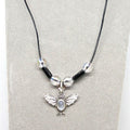 Necklace with a silver bat pendant on a gray background