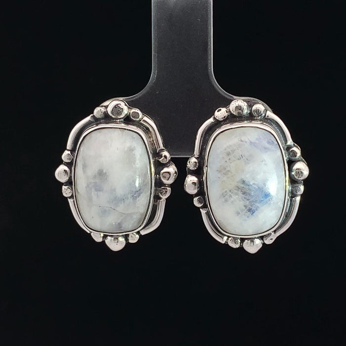 photo of a pair of sterling silver white moonstone earrings on a black background