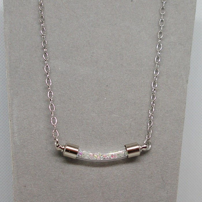 Silver necklace with a bar pendant on a gray card