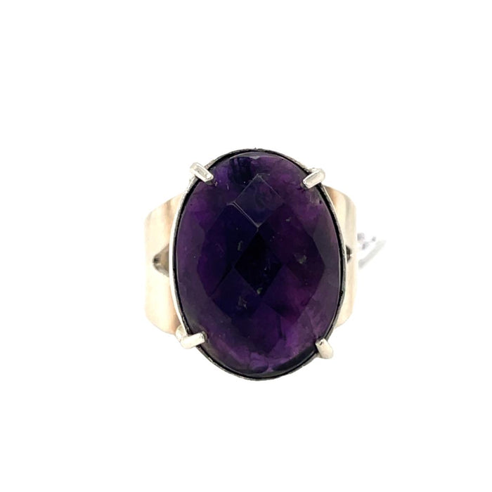 photo of a silver oval faceted amethyst ring on a white background front view