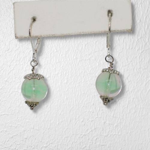 Pair of earrings with green beads on a white background
