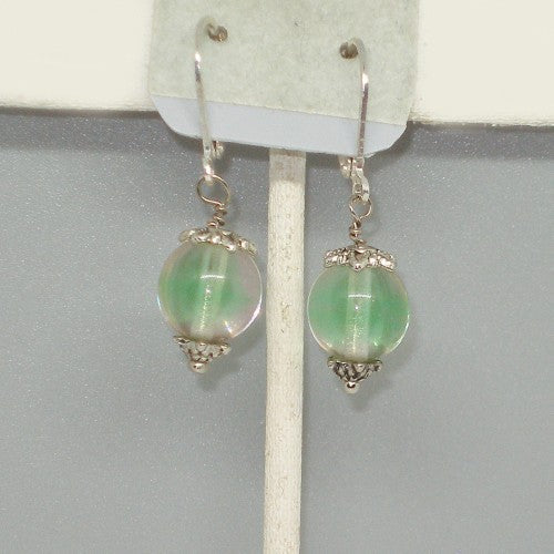 Green beaded earrings on a gray background