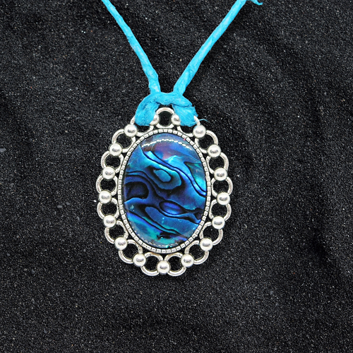 Necklace with a blue pendant on a black background