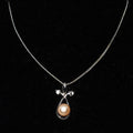 Necklace with a pendant featuring a pearl on a black background