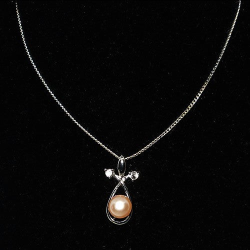 Necklace with a pendant featuring a pearl on a black background