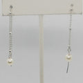 Pair of pearl earrings on a white background