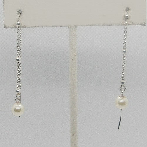 Pair of pearl earrings on a white background