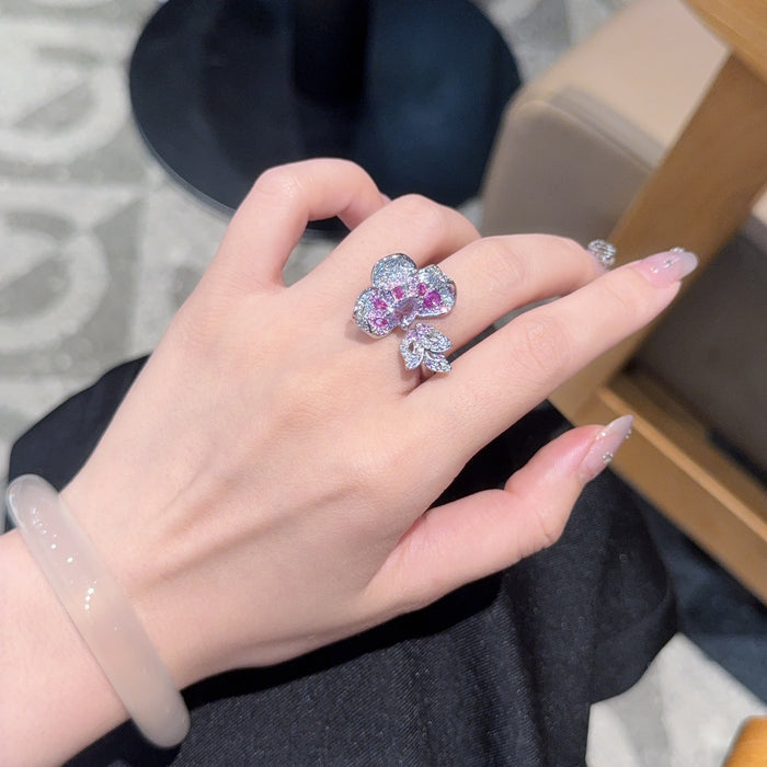 Elegant, glamorous, and rich with a royal touch, the Lavender Crown Ring is designed for someone who loves bold statement jewelry with refined sparkle. Featuring a striking lavender-purple centerpiece surrounded by rows of shimmering crystal-style accents, this ring creates a luxurious layered look while the adjustable opening keeps it comfortable and easy to wear.