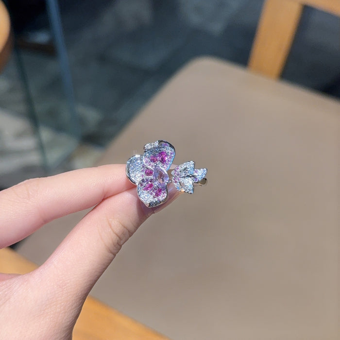Elegant, glamorous, and rich with a royal touch, the Lavender Crown Ring is designed for someone who loves bold statement jewelry with refined sparkle. Featuring a striking lavender-purple centerpiece surrounded by rows of shimmering crystal-style accents, this ring creates a luxurious layered look while the adjustable opening keeps it comfortable and easy to wear.