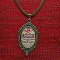 Medallion with 'POISON' label on a red fabric background