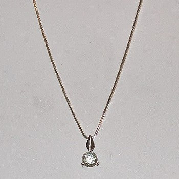 Necklace with a green gemstone pendant on a light gray background