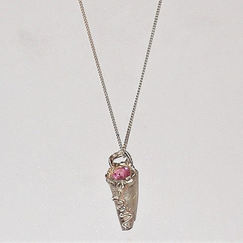 Silver pendant with a pink gemstone on a light gray background