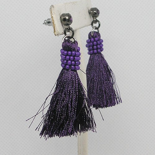 Purple beaded tassel earrings on a white background