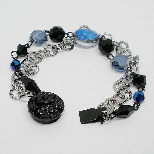 Bracelet with black and blue beads on a white background
