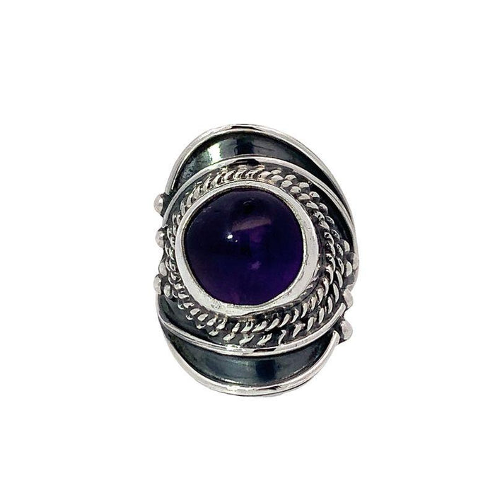 photo of a silver wide tapering band ring set with a round cabochon amethyst on a white background front view